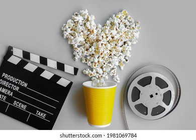 
Heart Made Of Popcorn, Film Strip And Clapperboard On A Gray Background. Copy Space. Flatlay Style. Movie Night, Film Viewing