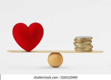 Heart and money on balance scale - Order of priority in life among love and money - Shutterstock ID 1265133490