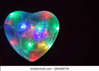 heart of multicolored lights on a dark background