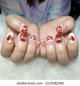 Heart Nail Art White And Nude Orange Attach Diamonds With A Bow Make It Beautiful And Cute On A White Background.