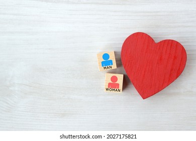 Heart object and wooden blocks with male and female human pictogram