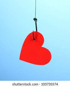 Heart On Fish Hook On Blue Background