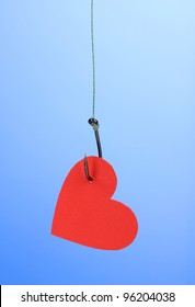 Heart On Fish Hook On Blue Background