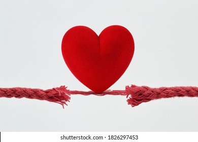 Heart on nearly broken rope - Concept of love and risk - Shutterstock ID 1826297453