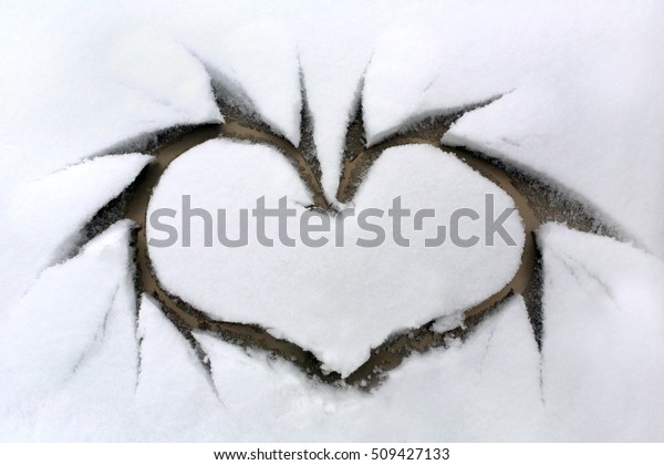 Heart on snowy\
window