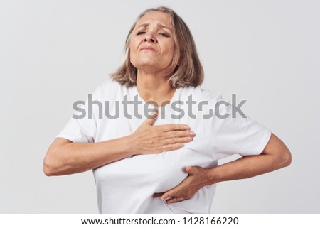 Heart pain elderly woman white jersey chest swelling health problems               