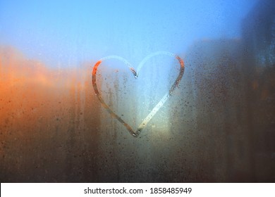 A heart painted on a fogged window.Heart on the fogged glass. Heart on the background of the window.The heart is a symbol of love drawn on glass