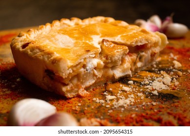 Heart Of Palm Pie On A Tree Trunk With Garlic And Spread Paprika On A Wooden Table.