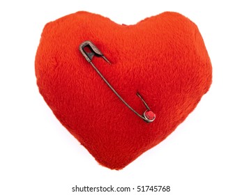 Heart Pierced With Old Vintage Brooch Pin Over White Background