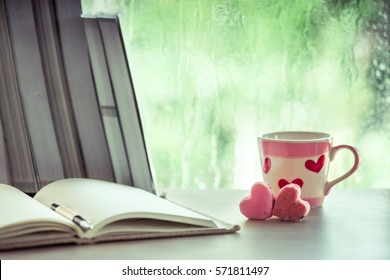 heart pink cookies and coffee cup with notebook on rainy day window background in vintage color tone - Powered by Shutterstock