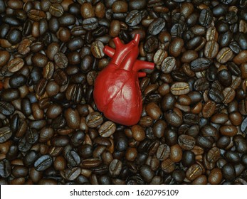 Heart Plastic Model On The Coffee Bean Background