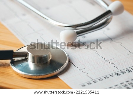 Heart rate EKG chart and medical stethoscope, concept, health check and examination, myocardial infarction suspected.