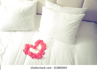 Heart Of Red Petals On Bed