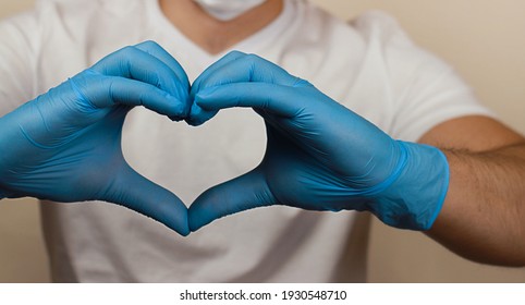 a heart shape from blue-gloved hands. a holiday greeting card from the bottom of your heart. - Shutterstock ID 1930548710