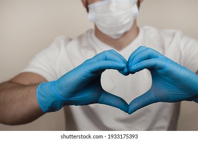 a heart shape from blue-gloved hands. a holiday greeting card from the bottom of your heart. - Shutterstock ID 1933175393
