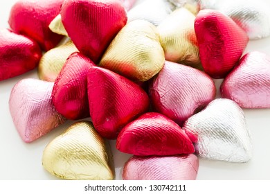 Heart Shape Chocolate Candies Wrapped In Colorful Foil For Valentine's Day.