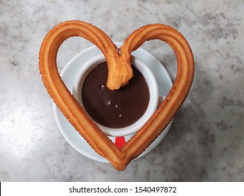 Heart Shape Of Churro And Hot Chocolate Cup On Table In The Bar Madrid Spain Photo Isolate On Grey Top View 