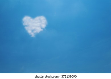 Heart shape cloud on blue sky