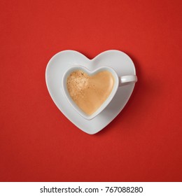 Heart Shape Coffee Cup Over Red Background. View From Above