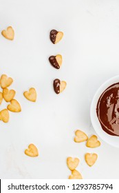 Heart Shape Cookies For Valentines Day Covered With Chocolate On Light Marble Background. Top View, Flat Lay.