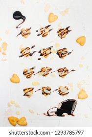 Heart Shape Cookies For Valentines Day Covered With Chocolate And Almonds On Light Marble Background. Top View, Flat Lay.