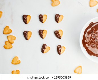 Heart Shape Cookies For Valentines Day Covered With Chocolate On Light Marble Background. Top View, Flat Lay.