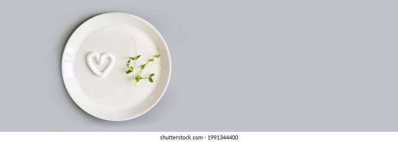 Heart Shape Cream. Beauty Lotion. Mayonnaise Smear On White Plate. Top View With Copyspace. White Product Smear. Valentine Concept. Horizontal Banner. Green Peas. Grey Background