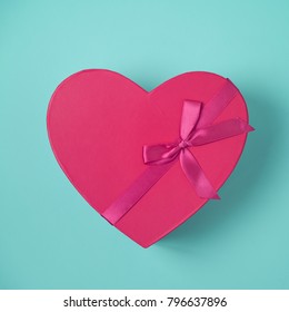 Heart Shape Gift Box Over Blue Background. Top View