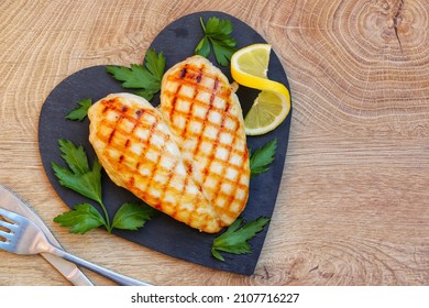 Heart Shape Grilled Chicken Breast On Heart Shape Slate Plate With Wooden Background.Love Healthy Food Concept For Valentine's Day.Top View.Copy Space