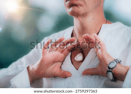 Heart shape with hands while focusing on the heart center during meditation. The gesture symbolizes love, emotional balance, spiritual awareness, and inner healing.