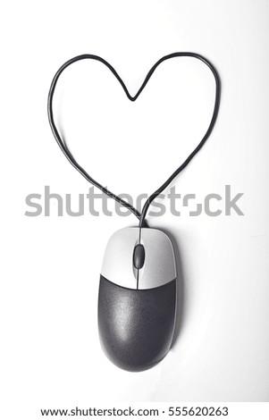 Heart made of wire in front of brick wall