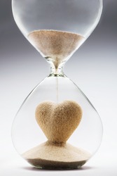Heart Shape Made Out Of Falling Sand Inside Hourglass