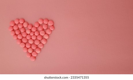 Heart shape Pink candy chips on pink gradation background with copy space. Pink glazed chocolate buttons. Suitable for Valentine's Day and Mother's Day decoration. Backdrop for beauty product display. - Powered by Shutterstock