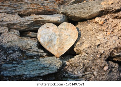 heart shape of rock between stones between dust and soil