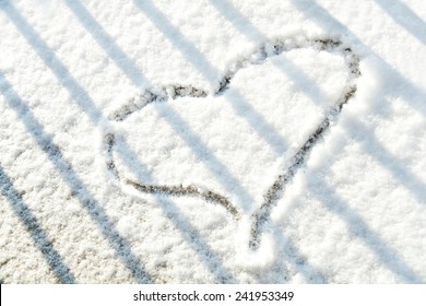 Heart Shape In The Snow Behind The Bars.