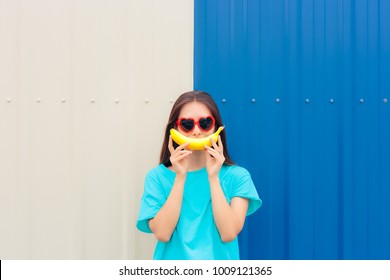 Heart Shape Sunglasses Woman With Funny Big Banana Smile. Loving Optimistic Stylish Girl With Big Fruity Smile 
