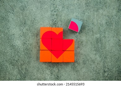 A heart shape in the wooden block is not complete, wait for on piece to fulfill the shape. Conceptual of love or broken heart. - Shutterstock ID 2145515693