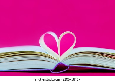 heart shaped book. Pages of a book curved into a heart shape. Opened book, pages shaped to form a heart	