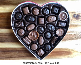 Heart Shaped Box Of Valentine’s Day Chocolates On A Wooden Table