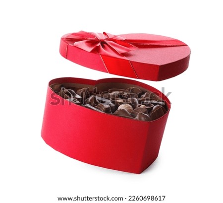 Heart shaped box with delicious chocolate candies on white background