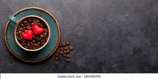 Heart shaped candies over coffee beans in cup. Valentines day card. Top view flat lay with space for your greetings - Powered by Shutterstock