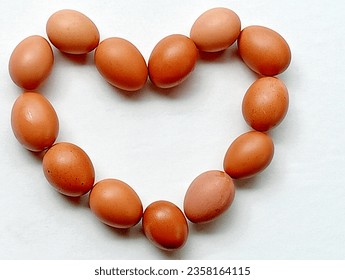 Heart shaped chicken eggs on a white background.