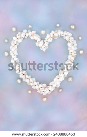 Heart shaped cockleshell wreath with oyster pearls on rainbow sky cloud background. Symbol of nature sea life summer love. Greetings card for Valentines, birthday, mothers day or anniversary.