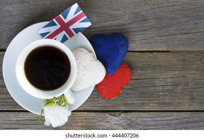 Heart shaped cookies color red, blue, white. Cup of coffee (tea), Flags  United Kingdom, UK.  decoration on old wooden table. Patriotic Breakfast Concept - Powered by Shutterstock