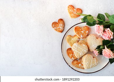 Heart shaped cookies and pink flowers roses for valentine's day , copy space - Powered by Shutterstock