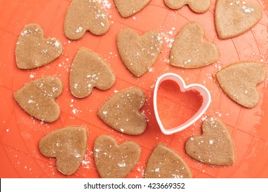 Heart Shaped Dough For Cookies With Plastic Cutter On Silicon Baking Mat