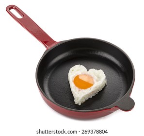 Heart Shaped Egg On Cast Iron Cookware Isolated On White Background.