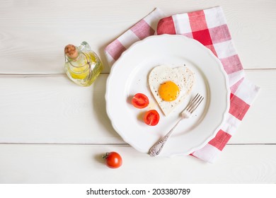 Heart Shaped Egg on the plate with tomatoes in Breakfast