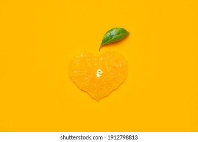 Heart Shaped Fresh Juicy Orange Slices, Green Leaves On Yellow Background. Flat Lay Top View. Fruit Pattern, Creative Bright Summer Love Concept. Minimalistic Background Citrus Fruits, Vitamin C