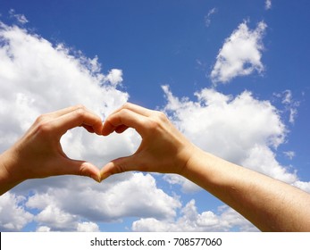 Heart Shaped Hands Against Summer Sky